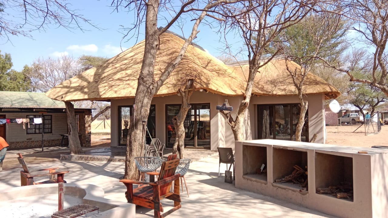 Thatched roof over a lodge-style building with outdoor living area